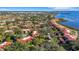 Expansive aerial view of a waterfront community with red tile roofs and lush trees at 6462 Wild Oak Bay Blvd # 247, Bradenton, FL 34210