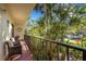 Balcony with seating and views of tropical landscaping at 6462 Wild Oak Bay Blvd # 247, Bradenton, FL 34210