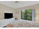 Bright bedroom with a queen-size bed and access to a private balcony at 6462 Wild Oak Bay Blvd # 247, Bradenton, FL 34210
