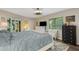 Bright bedroom featuring a king-size bed, dresser, and access to a private balcony at 6462 Wild Oak Bay Blvd # 247, Bradenton, FL 34210
