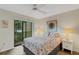 Bright bedroom with a comfortable bed and sliding glass door to balcony at 6462 Wild Oak Bay Blvd # 247, Bradenton, FL 34210