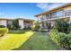 Two-story condo building with lush landscaping and a grassy lawn at 6462 Wild Oak Bay Blvd # 247, Bradenton, FL 34210