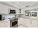 Modern white kitchen with stainless steel appliances at 6462 Wild Oak Bay Blvd # 247, Bradenton, FL 34210