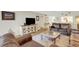 Living room featuring brown leather furniture, a coffee table, and wood floors at 6462 Wild Oak Bay Blvd # 247, Bradenton, FL 34210