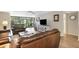 Living area with leather couches and access to balcony at 6462 Wild Oak Bay Blvd # 247, Bradenton, FL 34210