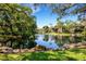 Serene pond with fountain, surrounded by lush trees and condo buildings at 6462 Wild Oak Bay Blvd # 247, Bradenton, FL 34210