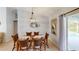 Dining area with a wooden table and chairs, unique light fixture, and pool view at 7306 Crock Ave, North Port, FL 34291