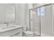 Modern bathroom featuring a glass-enclosed shower and a sleek white vanity with a marble countertop at 8007 Nevis Run, Bradenton, FL 34202