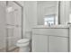 Modern bathroom featuring a glass shower and a vanity with white cabinets and a marble countertop at 8007 Nevis Run, Bradenton, FL 34202