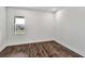 Empty bedroom with wood floors, white walls, and a window at 8007 Nevis Run, Bradenton, FL 34202