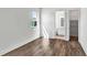 Bedroom with wood floors, white walls, a window, and doorways to a bathroom and closet at 8007 Nevis Run, Bradenton, FL 34202