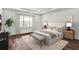 Bright bedroom featuring a large window, hardwood floors, and neutral decor at 8007 Nevis Run, Bradenton, FL 34202