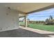Covered patio with brick flooring features space to entertain and relax while overlooking the green lawn at 8007 Nevis Run, Bradenton, FL 34202