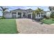 Beautiful single-Gathering home with a well-manicured lawn and an extended paver driveway to the garage at 8007 Nevis Run, Bradenton, FL 34202