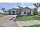 Charming home showcases landscaped greenery, a paver driveway, and meticulously maintained front yard at 8007 Nevis Run, Bradenton, FL 34202