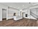 Open concept kitchen with white cabinets, stainless steel appliances and hardwood floors at 8007 Nevis Run, Bradenton, FL 34202