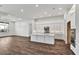 Kitchen with white cabinets, an island, stainless steel appliances, and hardwood floors at 8007 Nevis Run, Bradenton, FL 34202