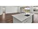 Kitchen featuring a large island, recessed lights, and a sliding glass door to the backyard at 8007 Nevis Run, Bradenton, FL 34202