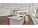 Kitchen featuring an island, recessed lights, and a sliding glass door to the backyard at 8007 Nevis Run, Bradenton, FL 34202