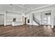 Open concept kitchen with white cabinets, stainless steel appliances and staircase at 8007 Nevis Run, Bradenton, FL 34202