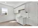 Laundry room with a sink, white cabinets, and a door to the side yard at 8007 Nevis Run, Bradenton, FL 34202