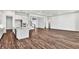 Open living room with wood floors, white walls, and large kitchen area at 8007 Nevis Run, Bradenton, FL 34202