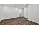 Spacious, open-concept living room with hardwood floors, white walls, and recessed lighting at 8007 Nevis Run, Bradenton, FL 34202