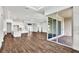 Open living room with wood floors, white walls, and sliding glass doors at 8007 Nevis Run, Bradenton, FL 34202