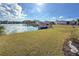 Waterfront property with a lake view, grassy area and a small boat at 808 53Rd E Ave # 142, Bradenton, FL 34203