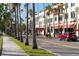 Street view of shops and restaurants along a palm tree-lined street at 1100 Tarpon Center Dr # 5B, Venice, FL 34285