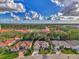 A bird's-eye view showcasing the home, its surrounding trees, and neighboring houses at 114 Fieldstone Dr, Venice, FL 34292