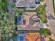 An aerial close-up highlighting the home's pool, roof, and backyard layout at 114 Fieldstone Dr, Venice, FL 34292