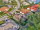 Aerial view of the home's tile roof, backyard, and surrounding neighborhood at 114 Fieldstone Dr, Venice, FL 34292