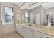 Bright bathroom with double vanity, large mirror, and modern fixtures at 114 Fieldstone Dr, Venice, FL 34292