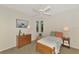 Bedroom with wooden furniture and soft, light blue bedding at 114 Fieldstone Dr, Venice, FL 34292