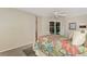 Spacious bedroom featuring a four-poster bed, ceiling fan, and sliding doors to a private outdoor space at 114 Fieldstone Dr, Venice, FL 34292
