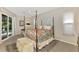 Main bedroom with four-poster bed, ceiling fan, and sliding glass door to the pool area at 114 Fieldstone Dr, Venice, FL 34292