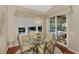 Breakfast nook with a glass-top table, stylish chandelier, and view of the patio at 114 Fieldstone Dr, Venice, FL 34292