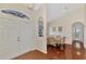 The foyer opens to a dining area with hardwood floors, and an arched pass-through at 114 Fieldstone Dr, Venice, FL 34292