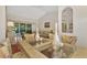 Dining room with a glass-top table, decorative vases, and view of the living room at 114 Fieldstone Dr, Venice, FL 34292