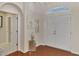 The foyer features hardwood floors, arched doorways, and a bright airy feel at 114 Fieldstone Dr, Venice, FL 34292