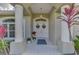 Inviting front porch with decorative columns, double doors, and holiday wreaths at 114 Fieldstone Dr, Venice, FL 34292