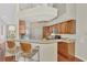 Bright kitchen featuring wood cabinets, stainless steel appliances, and a breakfast bar at 114 Fieldstone Dr, Venice, FL 34292