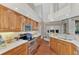 Kitchen with wood cabinetry, stainless steel appliances, and granite countertops at 114 Fieldstone Dr, Venice, FL 34292