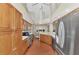 Modern kitchen with stainless steel appliances, wood cabinets, and ample counter space at 114 Fieldstone Dr, Venice, FL 34292