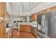 Updated kitchen with wood cabinets, stainless steel appliances, and a view of the dining area at 114 Fieldstone Dr, Venice, FL 34292