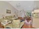 Open-concept living area with dining and kitchen access, and high vaulted ceiling at 114 Fieldstone Dr, Venice, FL 34292
