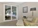Sitting area with sliding glass doors offering views of a private pool and patio at 114 Fieldstone Dr, Venice, FL 34292