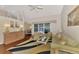 Inviting living room with high ceilings, wood floors, and sliding glass doors to the backyard at 114 Fieldstone Dr, Venice, FL 34292