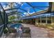 Spacious screened pool area with a retractable awning and paver deck at 114 Fieldstone Dr, Venice, FL 34292